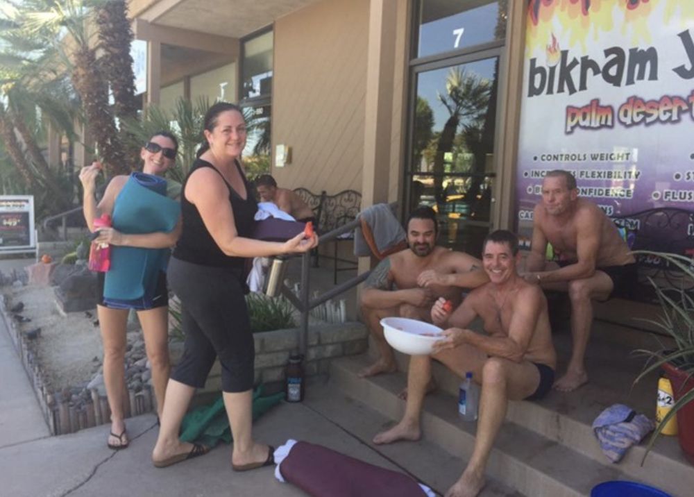 Bikram Yoga El Paseo students relaxing outside the studio, enjoying watermelon after class.