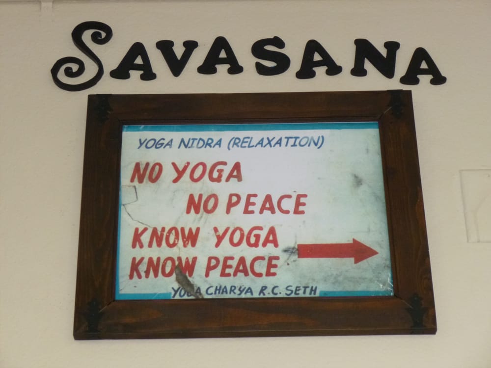 Wall sign inside Bikram Yoga El Paseo studio reading “No Yoga, No Peace. Know Yoga, Know Peace."